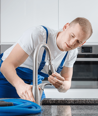 Professional plumber installing a modern faucet